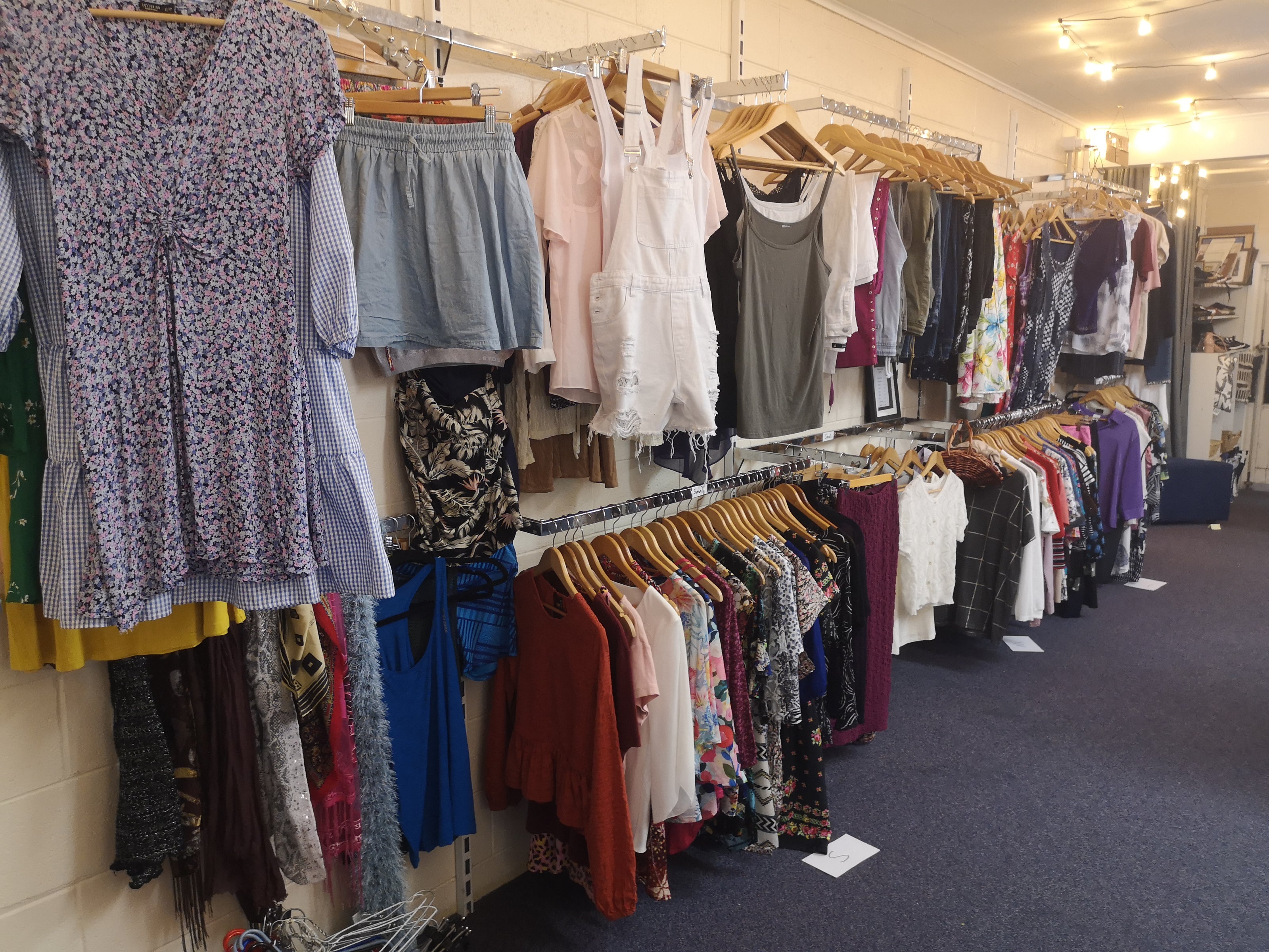 Clothing store with racks of clothes on hangers